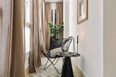 a living room with a table and a couch at Uru - 2 bedrooms and balcony in Vila de Gràcia in Barcelona