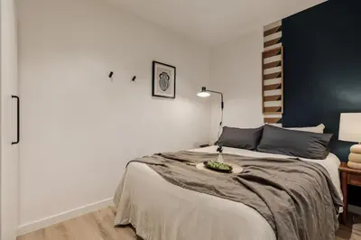 a bedroom with a bed with a table on it at Levent - 3 bedrooms and terrace in Sant Antoni in Barcelona