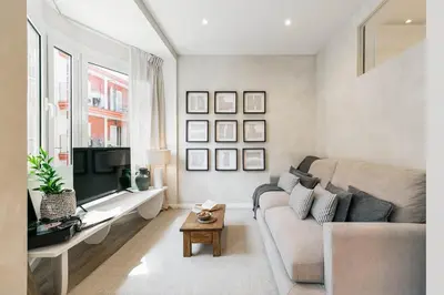 a bedroom with a bed and a desk and windows at Conca - 2 bedrooms apartment in Sant Gervasi in Barcelona