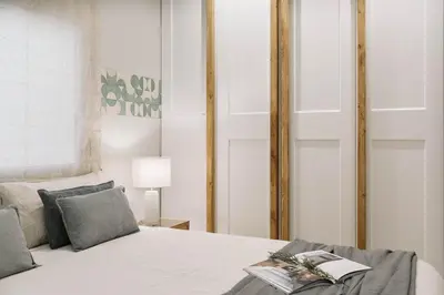 a white bedroom with a bed and a desk at Conca - 2 bedrooms apartment in Sant Gervasi in Barcelona