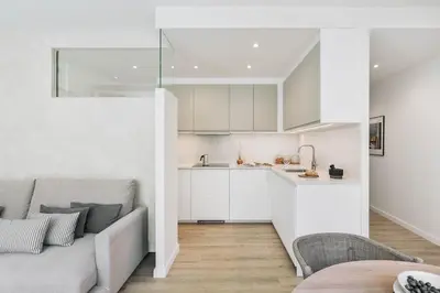 a living room with a couch and a kitchen at Conca - 2 bedrooms apartment in Sant Gervasi in Barcelona