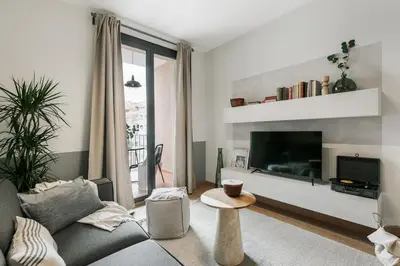a desk with a book and a lamp and some pictures at Furore - 1 bedroom in Eixample Esquerra in Barcelona