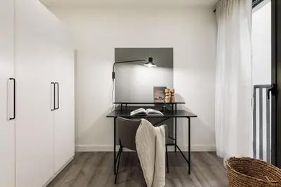 a living room with a couch and a table at Heures - 2 bedroom, office and pool in Les Corts in Barcelona