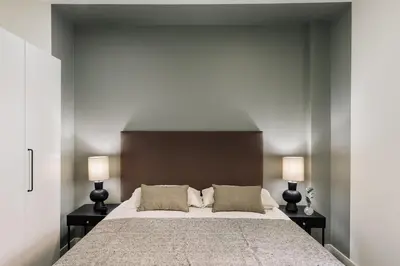 a living room with a couch and a table at Heures - 2 bedroom, office and pool in Les Corts in Barcelona