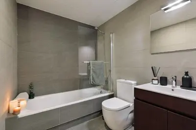 a desk in a room with a mirror and a chair at Heures - 2 bedroom, office and pool in Les Corts in Barcelona