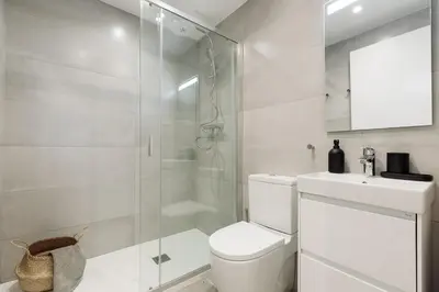 a white kitchen with a refrigerator and a sink at Cava - 2 bedrooms and terrace in Ciutat Vella in Barcelona