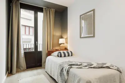 a living room with a couch and a table at Cava - 2 bedrooms and terrace in Ciutat Vella in Barcelona
