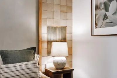 a lamp on a table next to a bed at Cadiar - 2 bedrooms in Eixample Esquerra in Barcelona