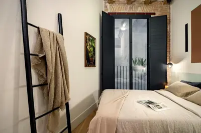 a dining room with a black table and chairs at Kasa - 2 bedrooms in Ciutat Vella in Barcelona