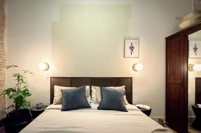 a bedroom with a bed and a large window at Kasa - 2 bedrooms in Ciutat Vella in Barcelona