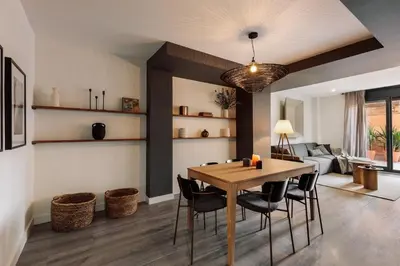 a black table with a mirror and a chair at Tortosa - 3 bedrooms and a terrace in Les Corts in Barcelona
