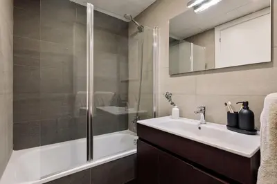 a bedroom with a large bed with two lamps at Tortosa - 3 bedrooms and a terrace in Les Corts in Barcelona