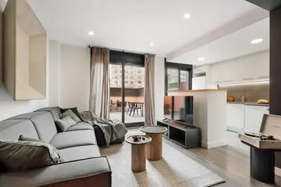 a bedroom with a bed and a desk and a chair at Tortosa - 3 bedrooms and a terrace in Les Corts in Barcelona