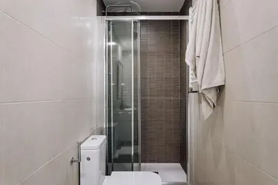 a bedroom with a large bed and a table at Seron - 3 bedrooms and office in Eixample Esquerra in Barcelona