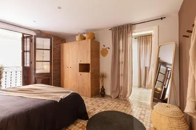 a bedroom with a bed and a large window at Amandi - 2 bedrooms in Gràcia in Barcelona