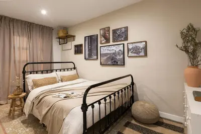 a kitchen with white walls and wooden cabinets at Amandi - 2 bedrooms in Gràcia in Barcelona