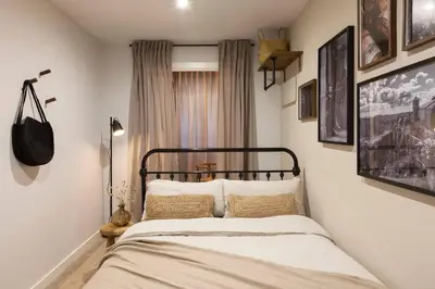 a bedroom with a blue bed with two pillows at Amandi - 2 bedrooms in Gràcia in Barcelona