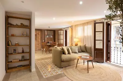 a kitchen and living room with a table and chairs at Amandi - 2 bedrooms in Gràcia in Barcelona