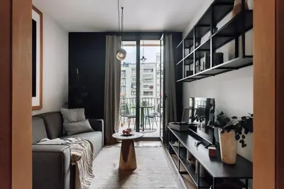 a kitchen with a wooden table and chairs at Biescas - 1 bedroom in Eixample Esquerra in Barcelona