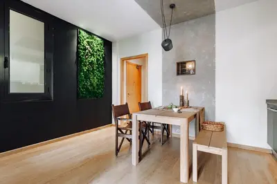 a bedroom with a large bed with a wooden headboard at Biescas - 1 bedroom in Eixample Esquerra in Barcelona