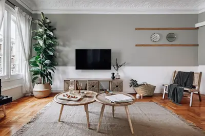 a white bedroom with a large bed and a chair at Olvera - 3 bedrooms in Eixample Dreta in Barcelona