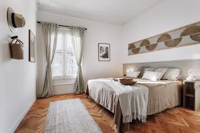 a living room with a potted plant and a chair at Olvera - 3 bedrooms in Eixample Dreta in Barcelona