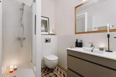 a bathroom with a tub and a toilet and a sink at Olvera - 3 bedrooms in Eixample Dreta in Barcelona