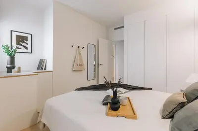 a kitchen with black and white counters and a sink at Haring - 2 bedrooms in Gràcia in Barcelona