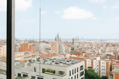 a kitchen and living room with a counter and a couch at Haring - 2 bedrooms in Gràcia in Barcelona