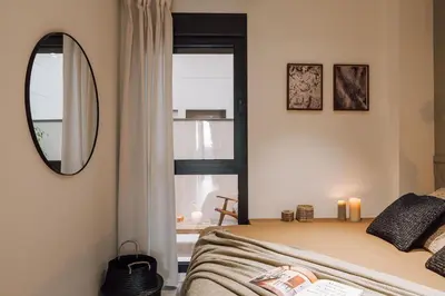 a hallway with a mirror and a living room at Pedrera - 2 bedrooms in Eixample Esquerra in Barcelona
