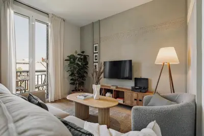 a living room with a couch and a tv at Atitlan - 3 bedrooms, office and balcony in Eixample Esquerra in Barcelona