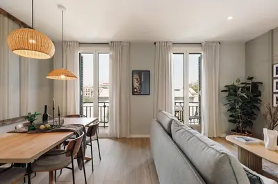 a hallway with white walls and a door leading to a kitchen at Atitlan - 3 bedrooms, office and balcony in Eixample Esquerra in Barcelona
