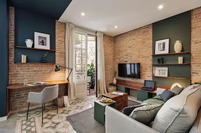 a living room with a brick wall at Cira - 2 bedrooms and balcony in Vila de Gràcia in Barcelona