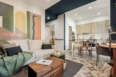 a living room with a couch and a brick wall at Cira - 2 bedrooms and balcony in Vila de Gràcia in Barcelona