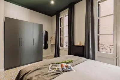 a bedroom with a bed with three mirrors on the wall at Cira - 2 bedrooms and balcony in Vila de Gràcia in Barcelona