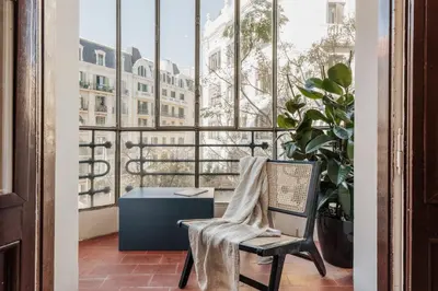 a brick wall with a desk with a lamp and a book at Cira - 2 bedrooms and balcony in Vila de Gràcia in Barcelona