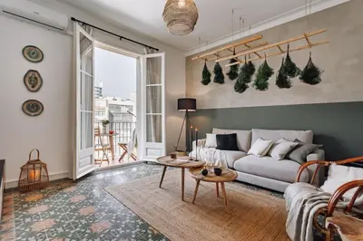a living room with a couch and a table at Baeza - 2 bedrooms and office in Eixample Esquerra in Barcelona