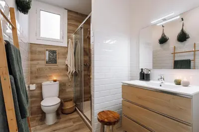 a black cabinet with baskets on top in a bedroom at Baeza - 2 bedrooms and office in Eixample Esquerra in Barcelona