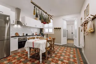 a kitchen with a table and chairs in a room at Baeza - 2 bedrooms and office in Eixample Esquerra in Barcelona