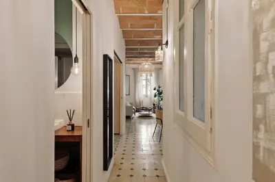 a living room with a dining room table and chairs at Cape - 2 bedrooms in Gràcia in Barcelona