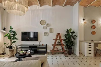 a living room with a couch and a table at Cape - 2 bedrooms in Gràcia in Barcelona