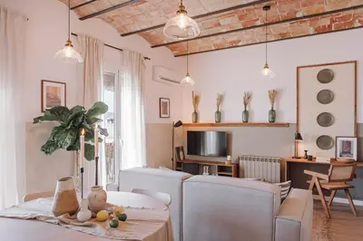 a living room with a couch and a table at Lugros - 3 bedrooms in Gràcia in Barcelona