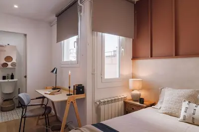 a hallway with a bench and a bag on the wall at Lugros - 3 bedrooms in Gràcia in Barcelona