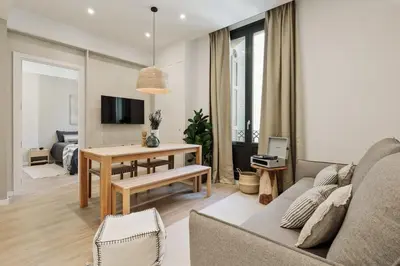 a kitchen and living room with a couch and a table at Batipaglia - 2 bedrooms and terrace in Ciutat Vella in Barcelona