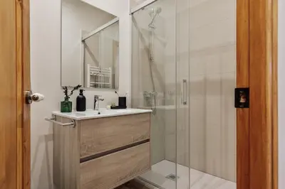 a pivot door in a room with a bedroom at Potosi - 3 bedrooms and balcony in Eixample Dreta in Barcelona
