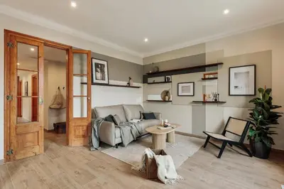 a bedroom with a large bed and a chair at Potosi - 3 bedrooms and balcony in Eixample Dreta in Barcelona