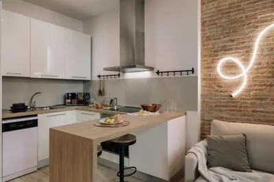 a living room with a couch and a brick wall at Chuck - 2 bedrooms and balcony in Sant Antoni in Barcelona