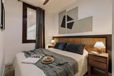 a kitchen and living room with a table and a couch at Chuck - 2 bedrooms and balcony in Sant Antoni in Barcelona