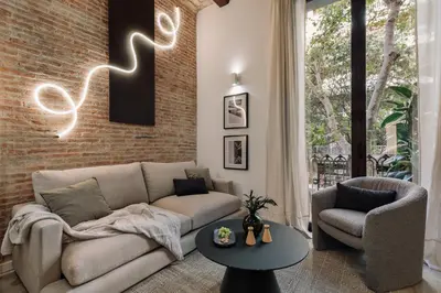 a kitchen and living room with a table and a couch at Chuck - 2 bedrooms and balcony in Sant Antoni in Barcelona