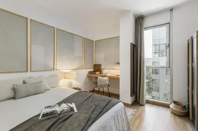 a bedroom with a bed with two books on it at Sabia - 2 bedrooms in Poblenou in Barcelona